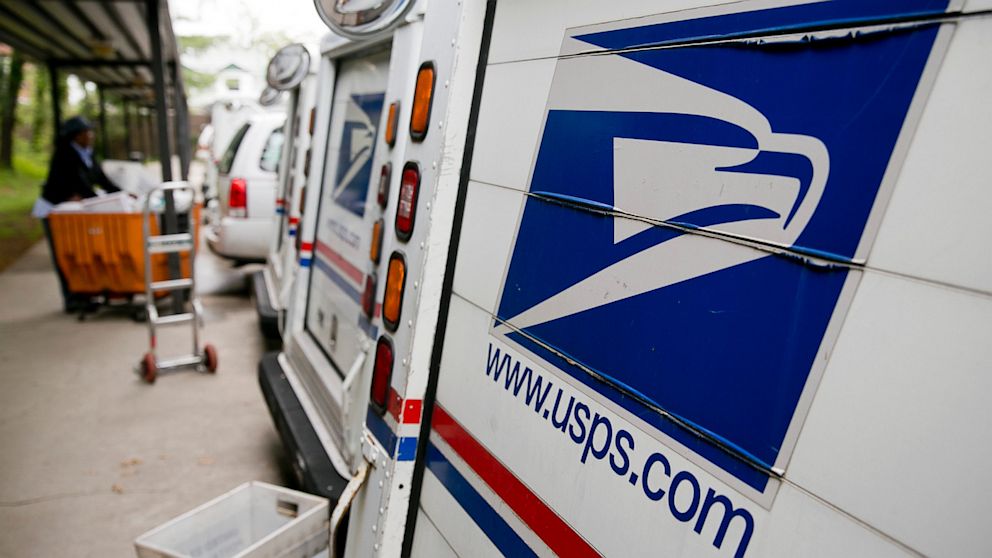 PHOTO: U.S. Postal Service delivery trucks sit at the Brookland Post Office in Washington, D.C., May 9, 2013.