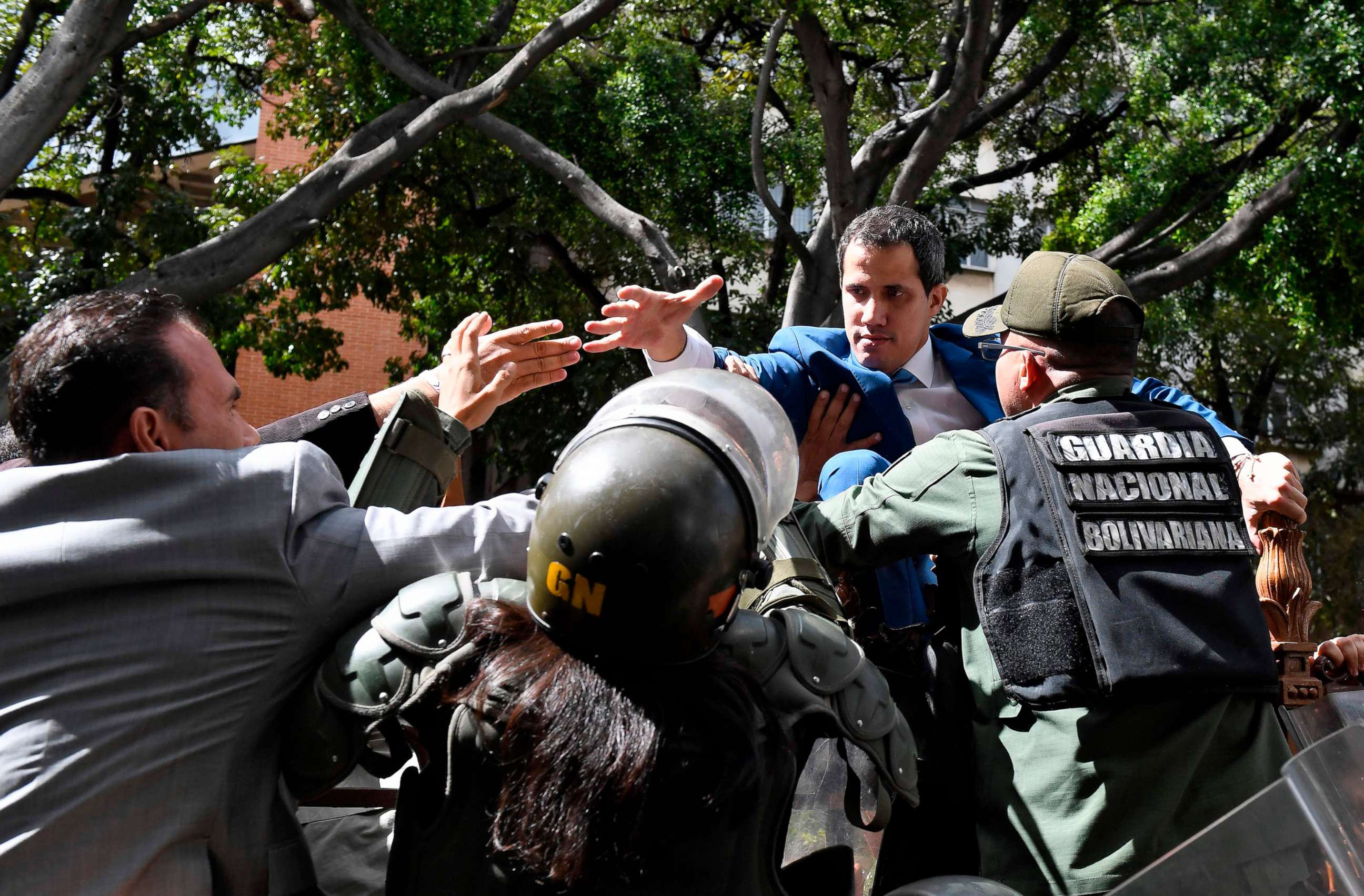 PHOTO: Venezuelan opposition leader Juan Guaido is blocked by security forces as he tries to reach the National Assembly building in Caracas by climbing over a fence, on Jan. 5, 2020.