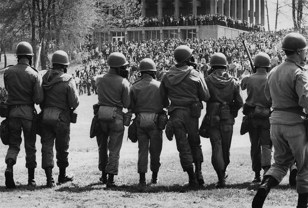 PHOTO: Members of the Ohio National Guard, with gas masks and fixed bayonettes, advance towards Blanket Hill to disperse antiwar demonstrators and students at Kent State University, Kent, Ohio, May 4, 1970.