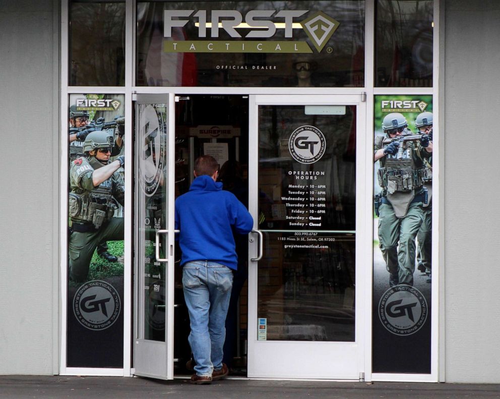 PHOTO: A man enters a gun shop in Salem, Ore, on Feb. 19, 2021, in Salem, Ore. So many guns are being purchased recently that the police are often unable to timely complete background checks, allowing the sales to proceed if the deadline isn't met.