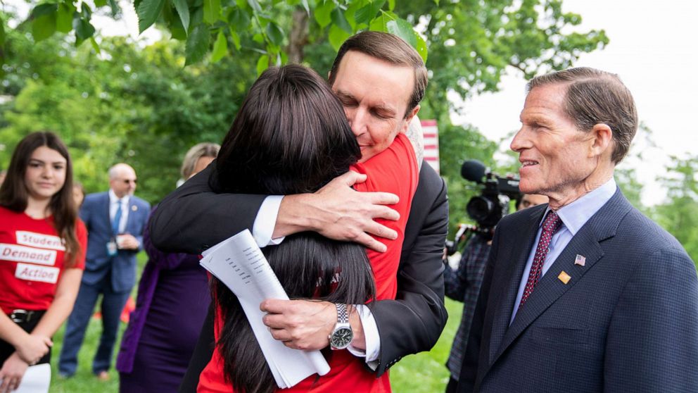 PHOTO: Sen. Chris Murphy hugs Erica Lafferty as Sen. Richard Blumenthal looks on during a rally to demand the Senate take action on gun safety in the wake of the Robb Elementary School shooting in Texas in Washington, May 26, 2022.