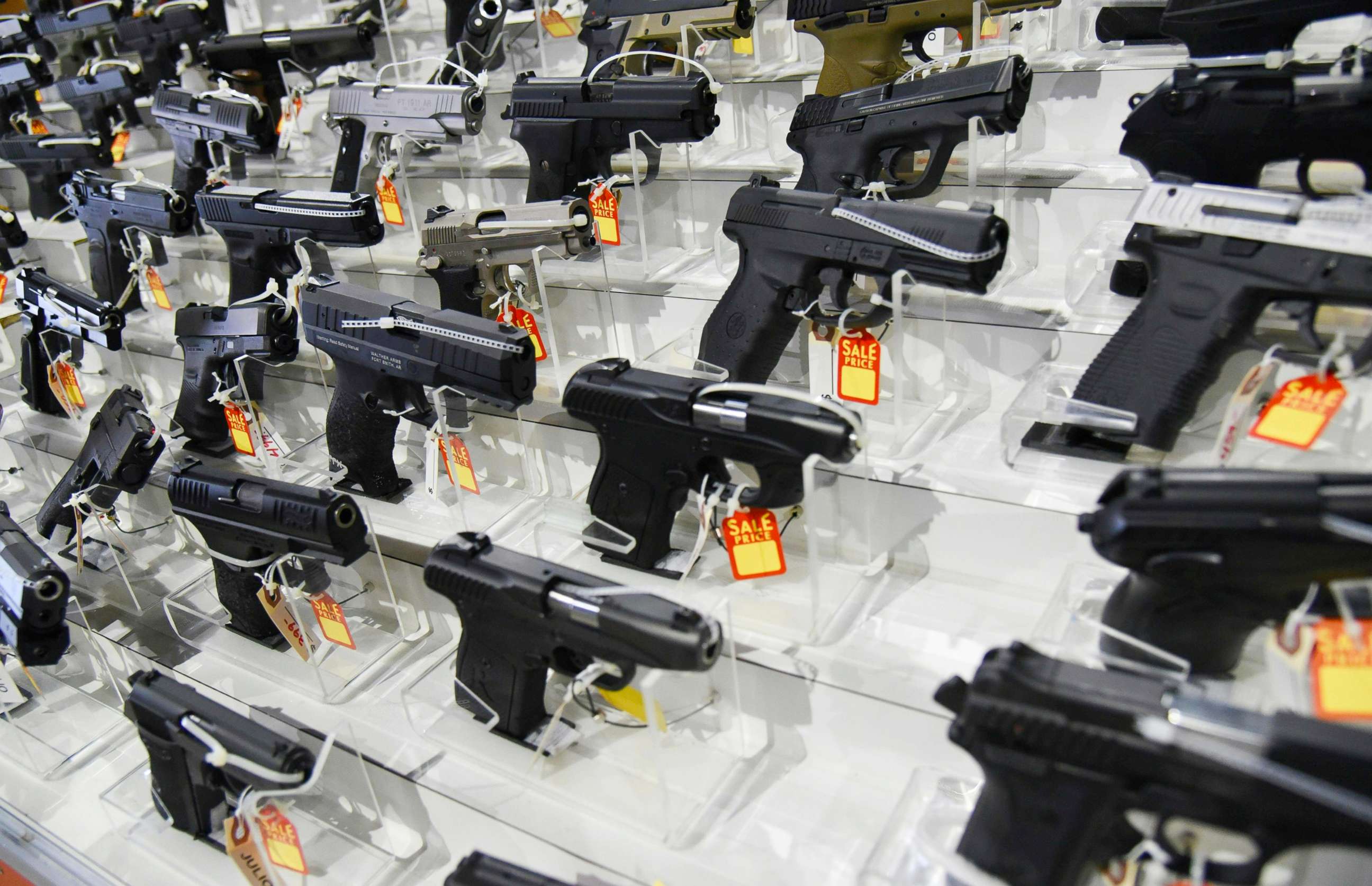 PHOTO: Guns lie in a booth during preparations for a gun show on Feb. 16, 2018, at the Dade County Youth Fairgrounds Fairgrounds in Miami.