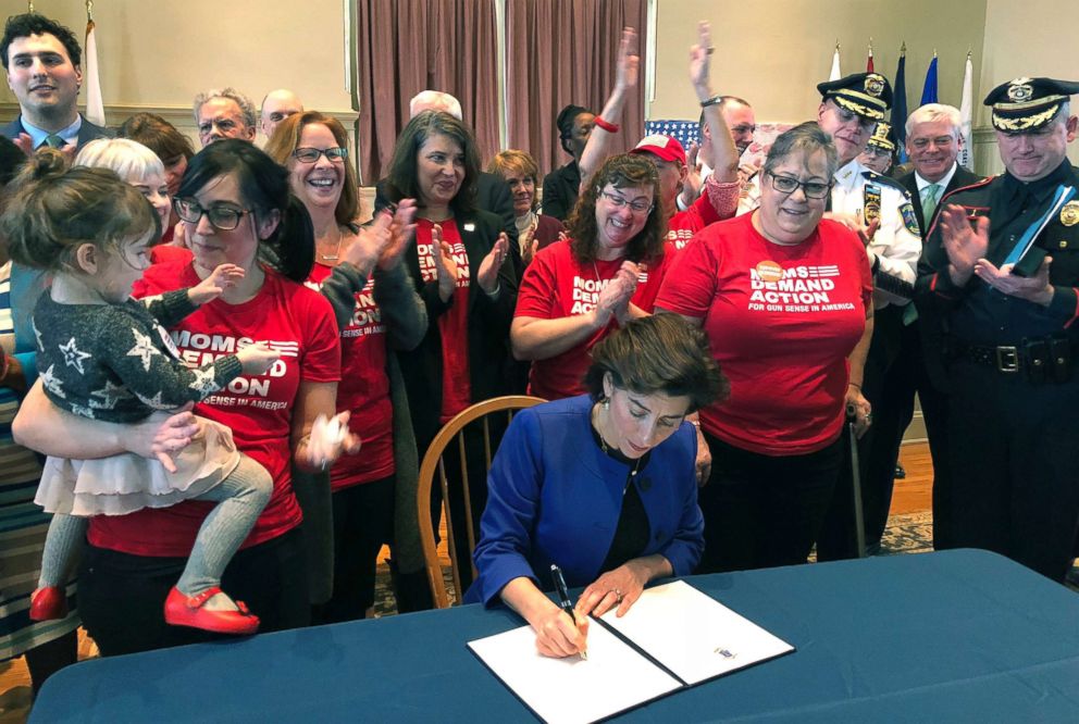 PHOTO: Cheers erupt as Rhode Island Governor Gina Raimondo signs an executive order, Feb. 26, 2018, in Warwick, R.I., establishing a new policy to try to keep guns away from people who show warning signs of violence.