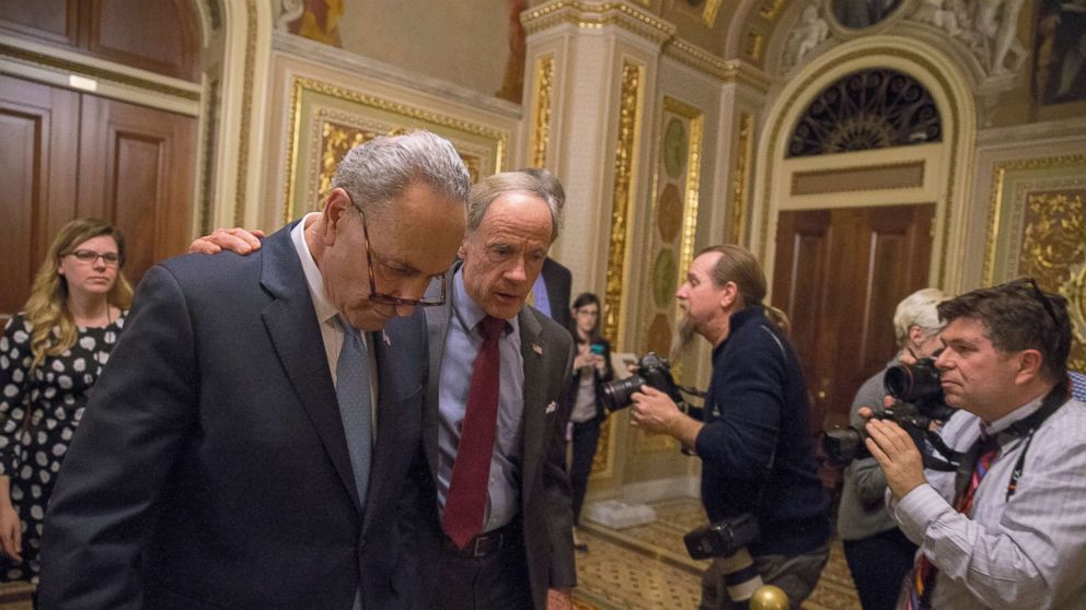 WASHINGTON, DC - JANUARY 19:  (L-R) Senate Minority Leader Chuck Schumer (D-NY) and Senator Tom Carper (D-DE) walk out of a Democratic Caucus meeting at the US Capitol on January 19, 2018 in Washington, DC. A continuing resolution to fund the government has passed the House of Representatives but faces a stiff challenge in the Senate.  