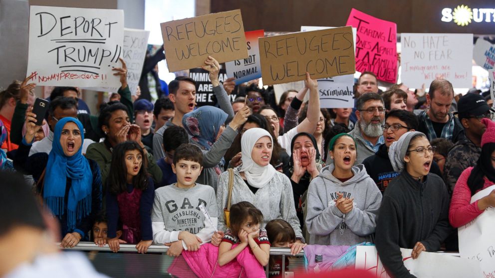 Protesters gather to denounce President Donald Trump's executive order that bans certain immigration, at Dallas-Fort Worth International Airport on January 28, 2017 in Dallas, Texas.