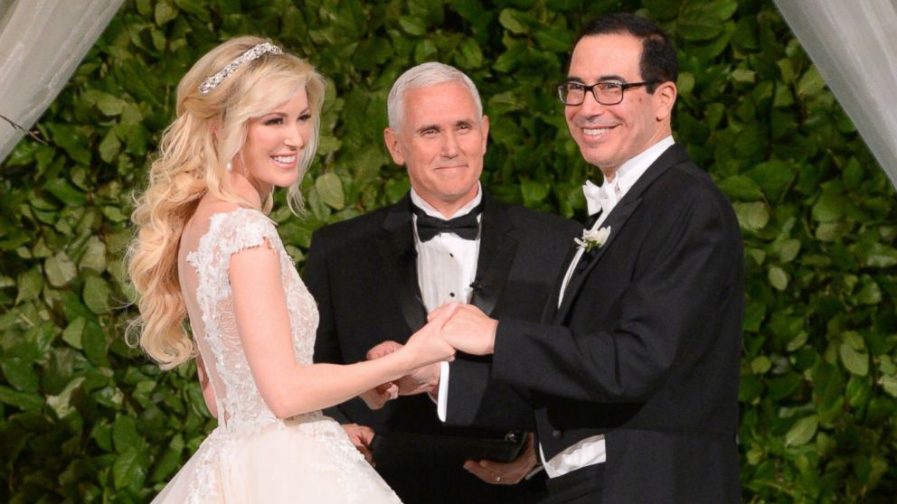 Vice President Mike Pence (C) officiates the wedding of  Louise Linton (L) and Secretary of the Treasury Steven Mnuchin (R) on June 24, 2017 at Andrew Mellon Auditorium in Washington, DC. 