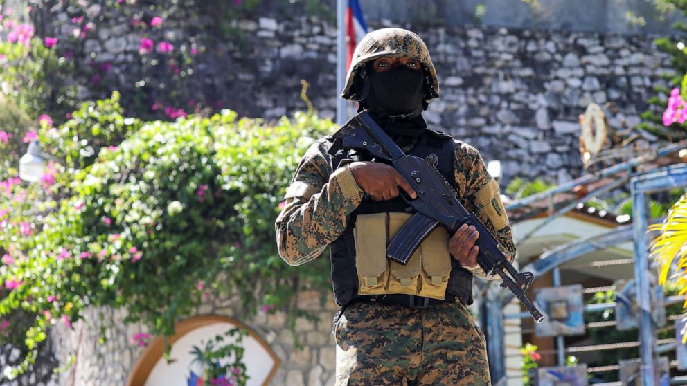 PHOTO:A Haitian police officer stands guard outside of the presidential residence, July 7, 2021, in Port-au-Prince, Haiti.