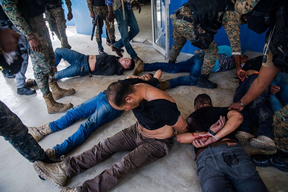 PHOTO: Police officers guard a group of alleged suspects in Port-au-Prince, Haiti, July 8,2021. 