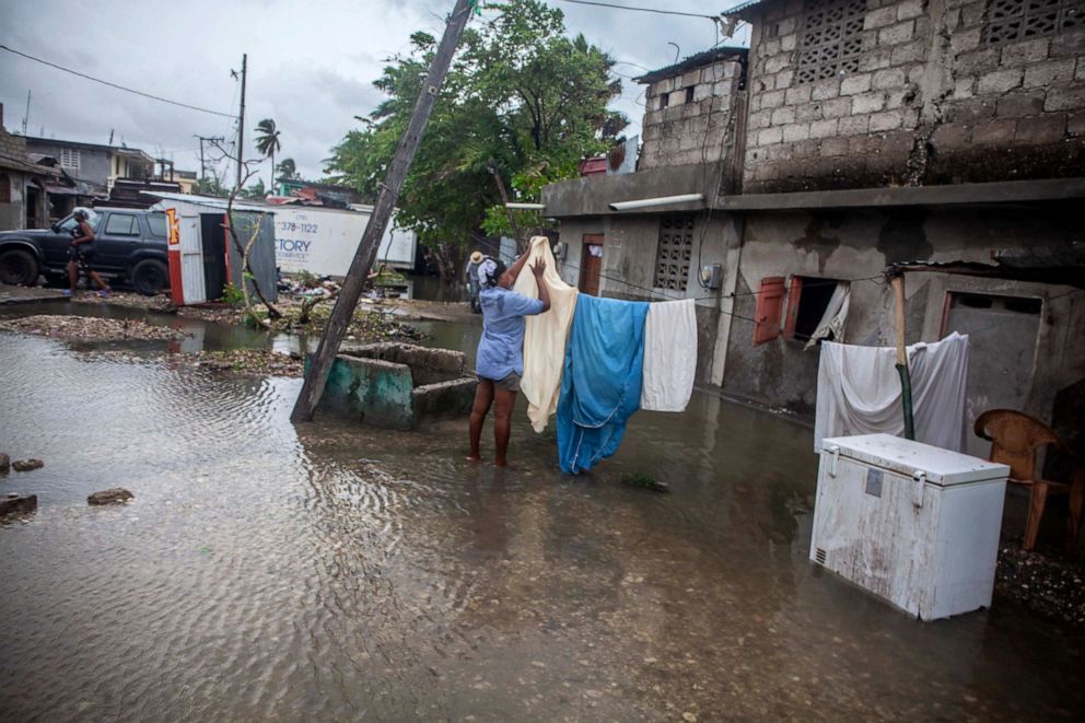PHOTO: A woman hangs linens to dry as heavy rain brought by tropical storm Grace hits Haitians just after a 7.2-magnitude earthquake struck Haiti, Aug. 17, 2021, in Les Cayes, Haiti.