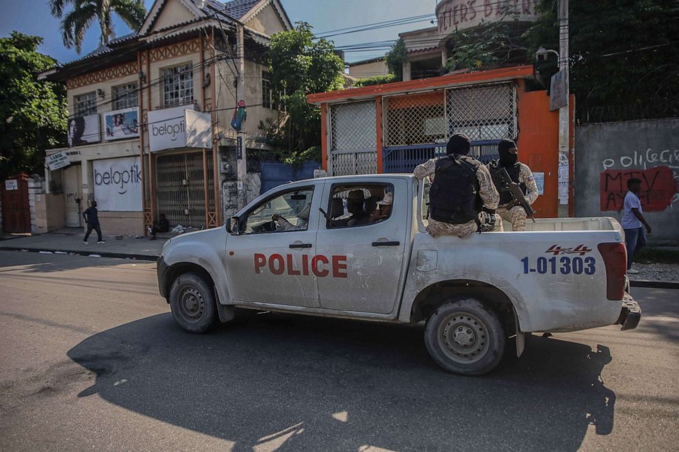 PHOTO: Armed police ride in the back of a truck after the streets of the Haitian capital Port-au-Prince were deserted following a call for a general strike to denounce insecurity on Oct. 18, 2021.