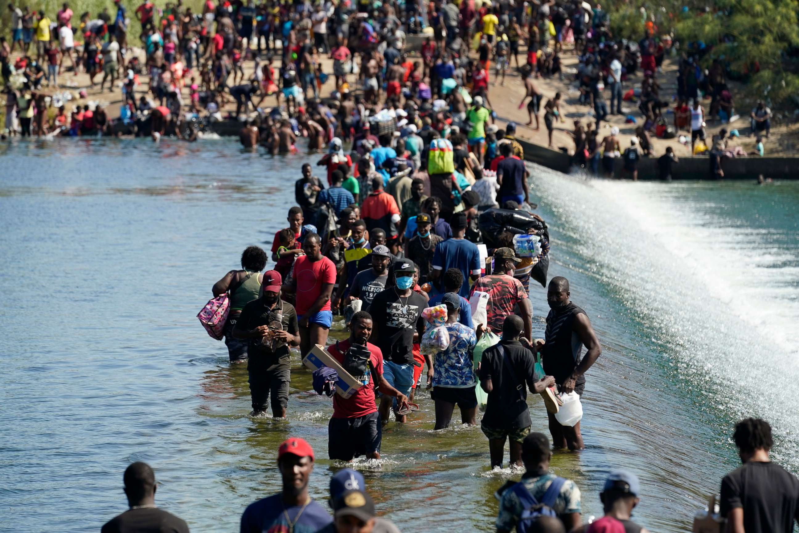 PHOTO: Haitian migrants use a dam to cross to and from the United States from Mexico, Sept. 17, 2021, in Del Rio, Texas.