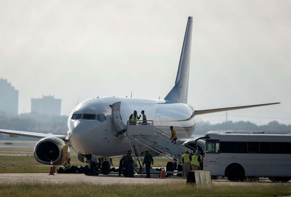 PHOTO: Haitian migrants board a chartered airplane at San Antonio International Airport, Sept. 20, 2021, in San Antonio. 
