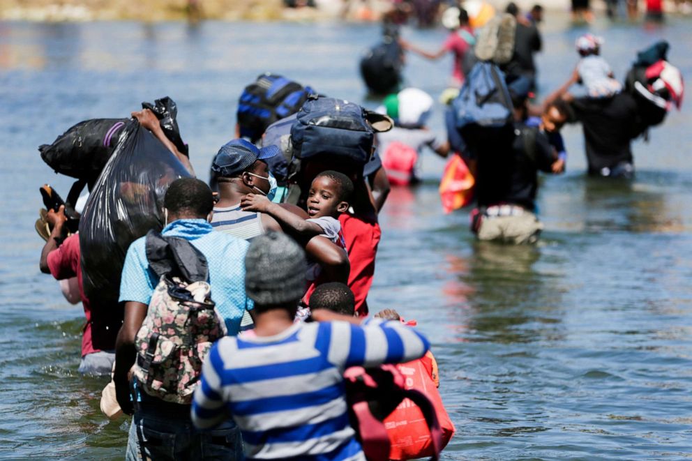 Migrants seeking refuge in the U.S. wade through the Rio Grande from Ciudad Acuna, Mexico toward Del Rio, Texas, on Sept. 23, 2021. 