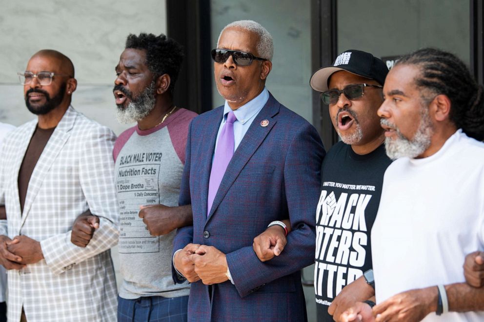 PHOTO: Rep. Hank Johnson and Cliff Albright, second from right, co-founder of Black Voters Matter, sing before being arrested during a protest to support voting rights outside of Hart Building in Washington, July 22, 2021.