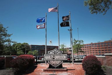 PHOTO: Flags fly in front of the headquarters of iconic American motorcycle builder Harley-Davidson on June 1, 2018 in Milwaukee, Wis.