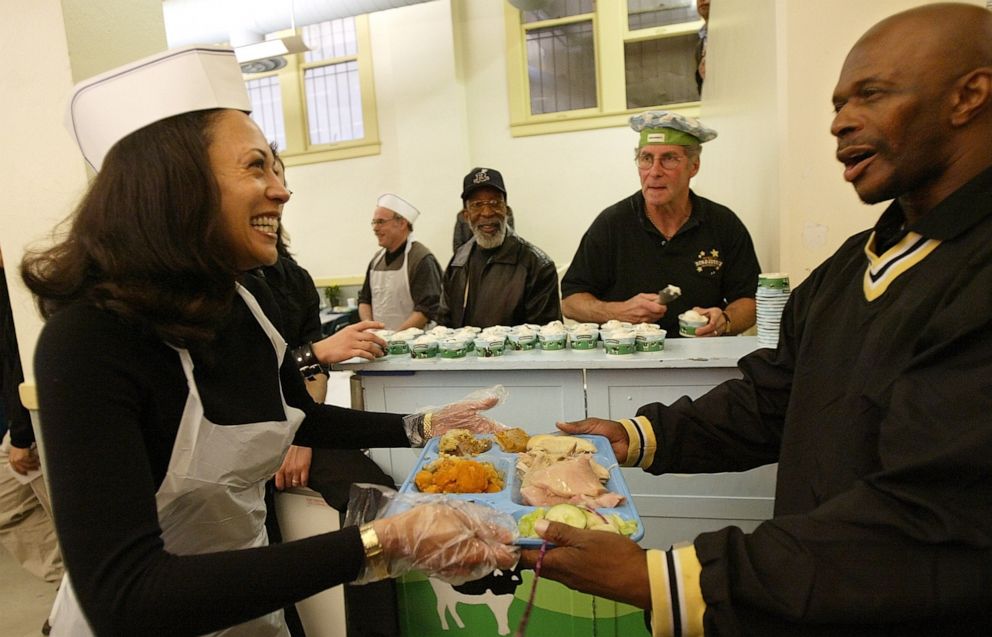 PHOTO: Then San Francisco district attorney candidate Kamala Harris, left, serves lunch to an unidentied visitor while volunteering at Thanksgiving service at Glide Memorial United Methodist Church in San Francisco on Thursday, Nov. 27, 2003.