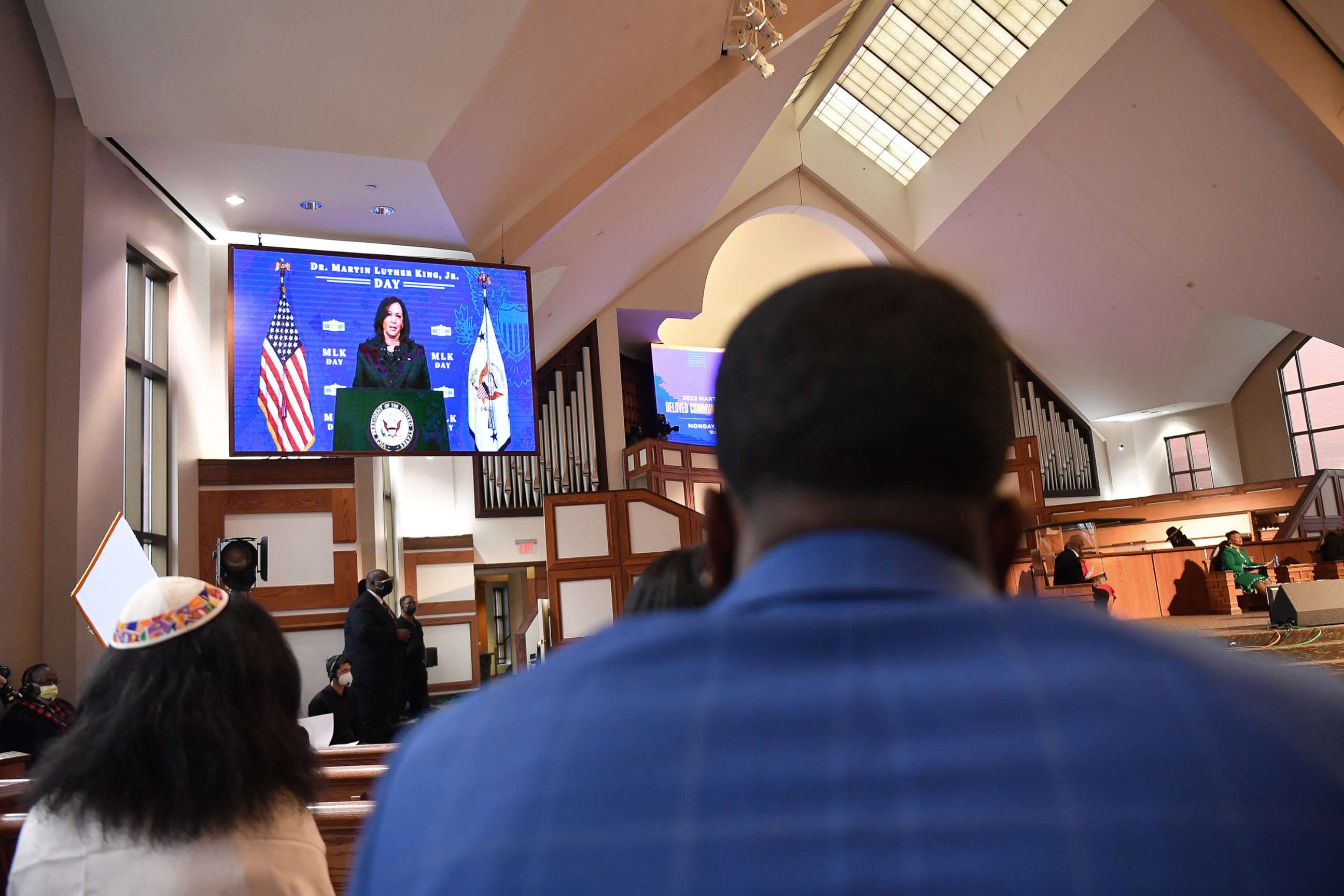 PHOTO: Attendees watch a recording of Vice President Kamala Harris during the 2022 King Holiday Observance Beloved Community Commemorative Service at Ebenezer Baptist Church, Jan. 17, 2022, in Atlanta.