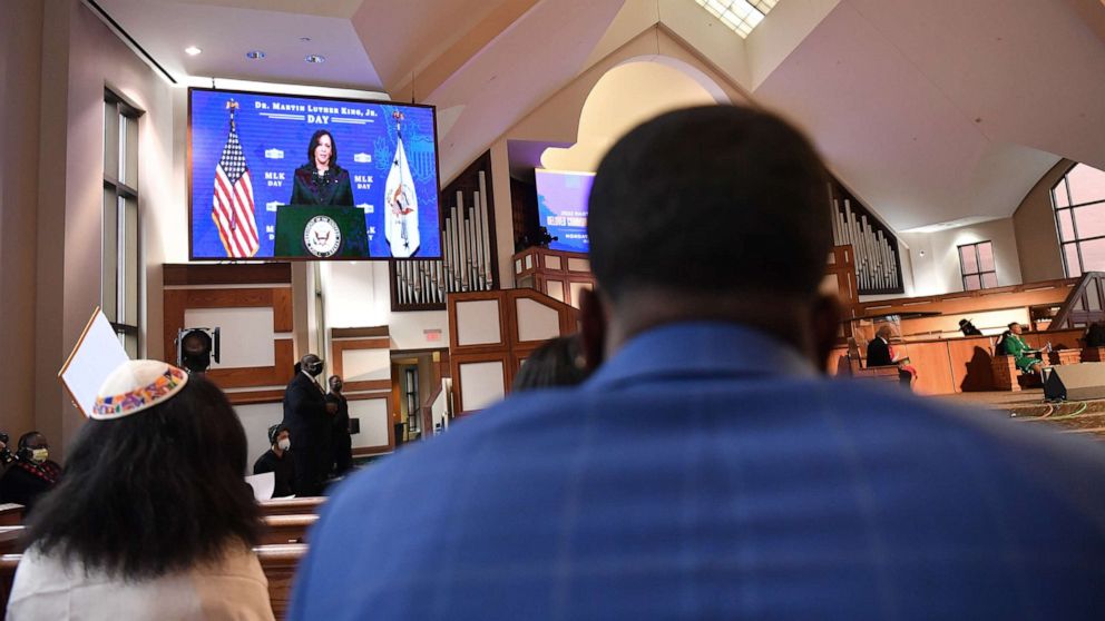 PHOTO: Attendees watch a recording of Vice President Kamala Harris during the 2022 King Holiday Observance Beloved Community Commemorative Service at Ebenezer Baptist Church, Jan. 17, 2022, in Atlanta.