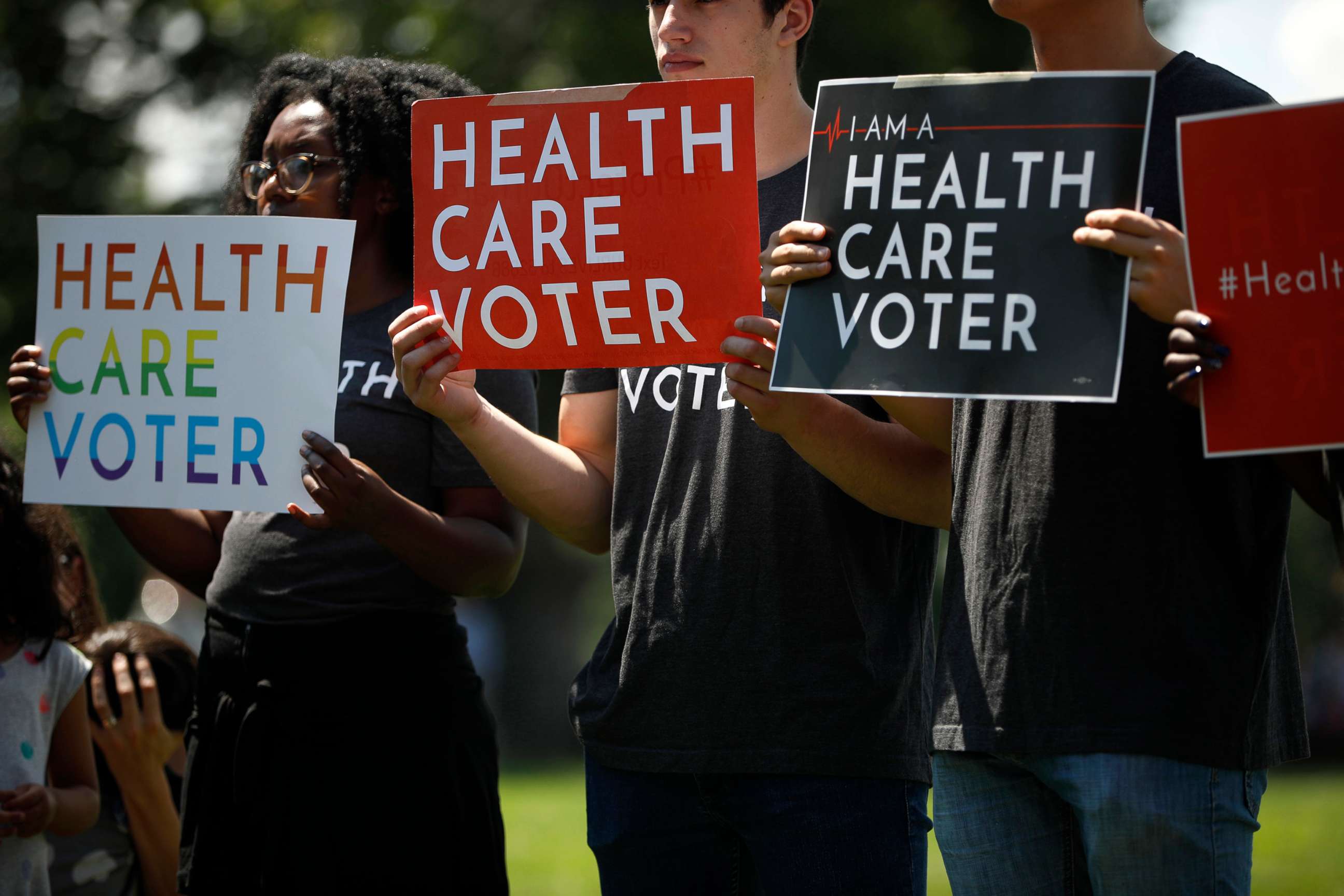 PHOTO: Demonstrators hold signs as Democratic leaders speak with reporters outside the Capitol Hill in Washington, June 26, 2018.