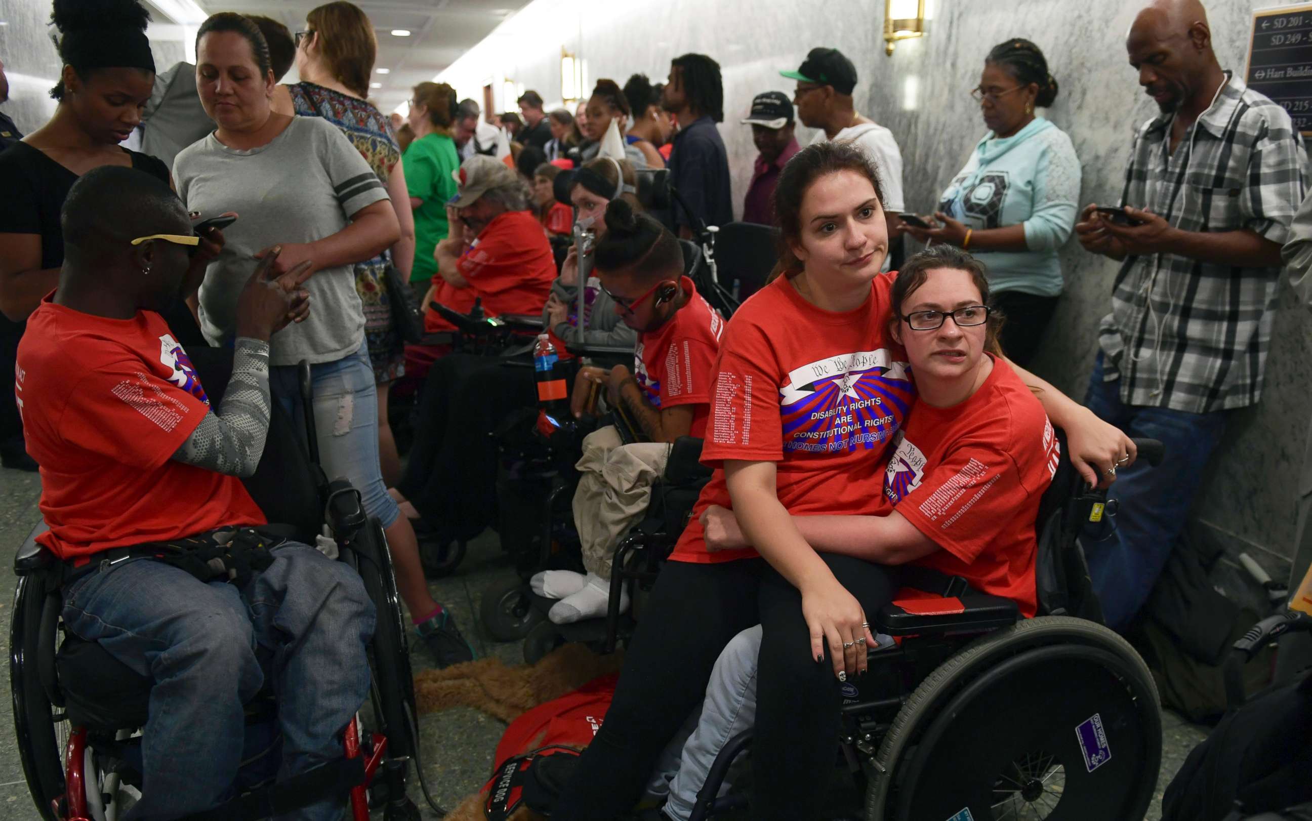 PHOTO: Shaylin Sluzalis, sits with her sister Brinnani Sluzalis, both of Williamsport, Pa., as they rally prior to a hearing by the Senate Finance Committee on the Graham-Cassidy health care repeal, in Washington, Sept. 25, 2017. 