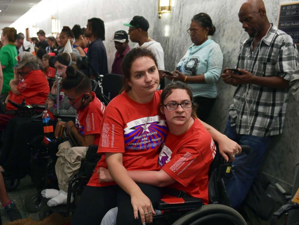 PHOTO: Shaylin Sluzalis, sits with her sister Brinnani Sluzalis, both of Williamsport, Pa., as they rally prior to a hearing by the Senate Finance Committee on the Graham-Cassidy health care repeal, in Washington, Sept. 25, 2017.