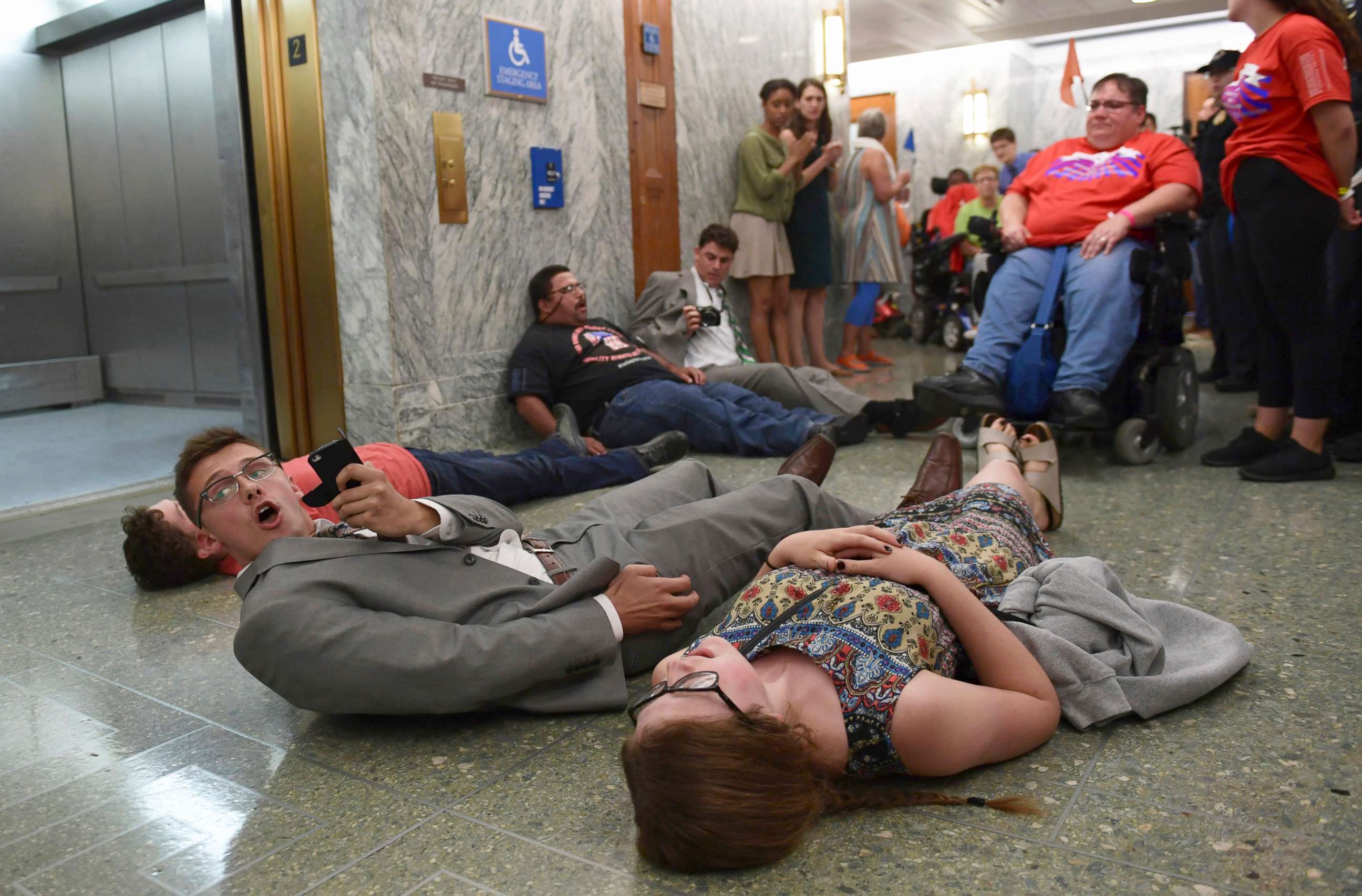 PHOTO: Protesters lay on the floor as they wait to be arrested by Capitol Police as they attempt to maintain order in the hallways on Capitol Hill in Washington, Sept. 25, 2017. 