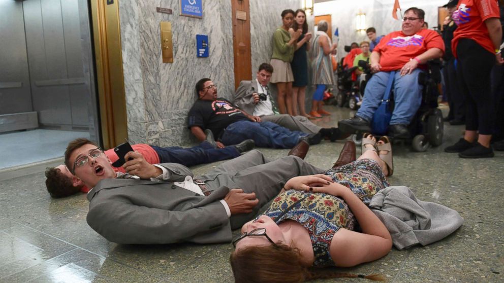 PHOTO: Protesters lay on the floor as they wait to be arrested by Capitol Police as they attempt to maintain order in the hallways on Capitol Hill in Washington, Sept. 25, 2017. 