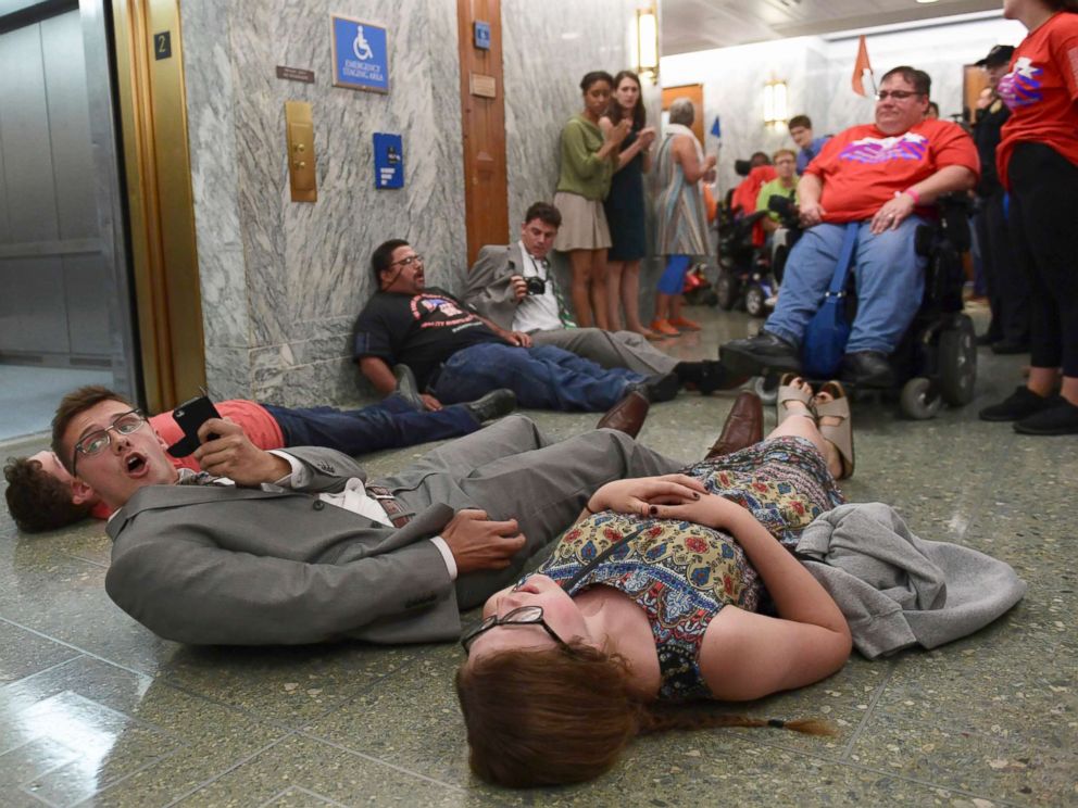 PHOTO: Protesters lay on the floor as they wait to be arrested by Capitol Police as they attempt to maintain order in the hallways on Capitol Hill in Washington, Sept. 25, 2017.