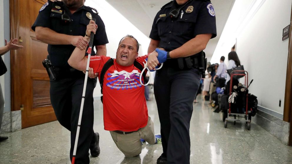 PHOTO: Capitol Police drag a blind protester out of a Senate Finance Committee hearing about the proposed Graham-Cassidy Healthcare Bill in the Dirksen Senate Office Building on Capitol Hill, Sept. 25, 2017, in Washington.