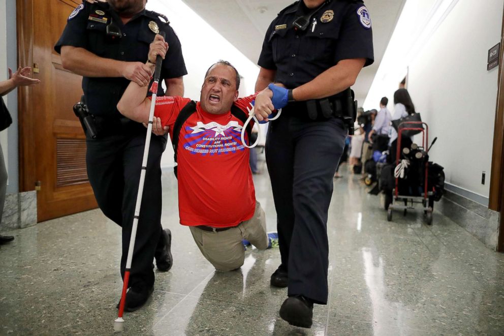 PHOTO: Capitol Police drag a blind protester out of a Senate Finance Committee hearing about the proposed Graham-Cassidy Healthcare Bill in the Dirksen Senate Office Building on Capitol Hill, Sept. 25, 2017, in Washington.