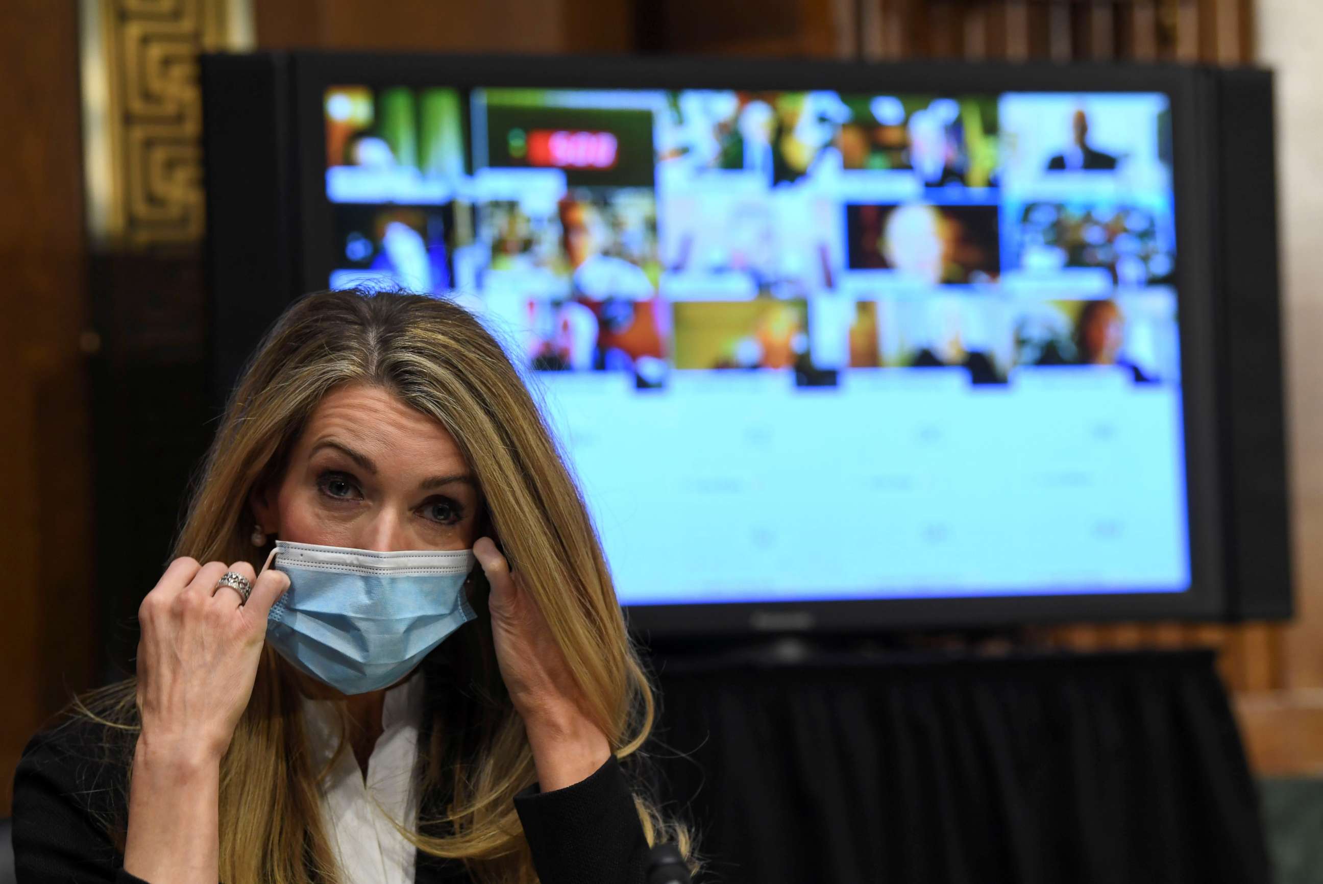 PHOTO: Senator Kelly Loeffler removes her mask before the Senate Committee for Health, Education, Labor, and Pensions hearing on the coronavirus disease (COVID-19), in Washington, May 12, 2020.
