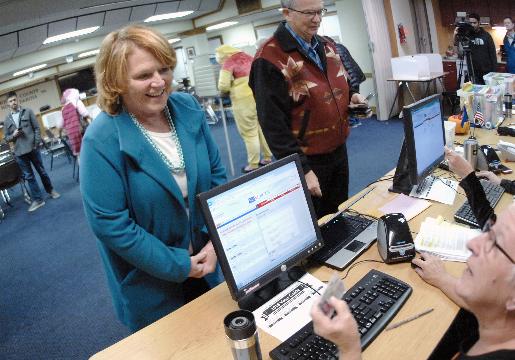 PHOTO: Sen. Heidi Heitkamp talks with a precinct worker before casting her vote at an early voting precinct inside the Morton County Courthouse, Oct. 31, 2018, in Mandan, N.D.