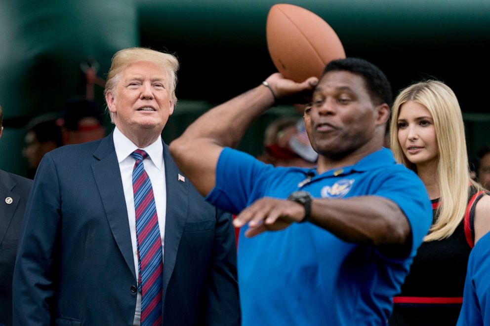 PHOTO: In this May 29, 2018 file photo, President Donald Trump, left, and his daughter Ivanka Trump, right, watch as former football player Herschel Walker, center, throws a football on the South Lawn of the White House in Washington.