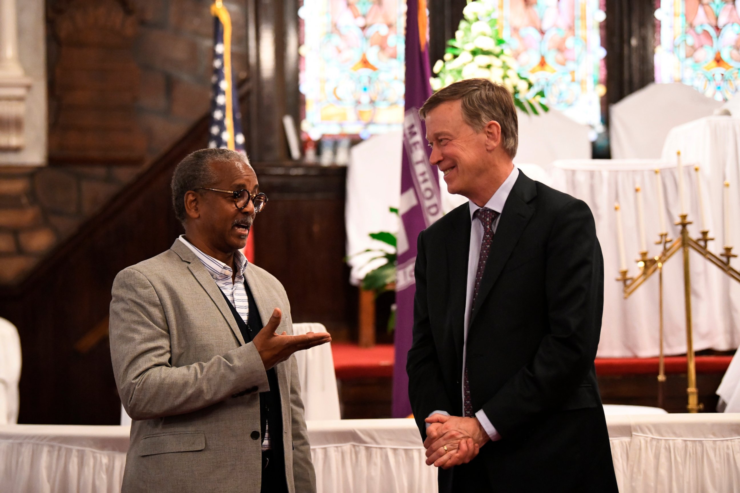 PHOTO: Former Colorado Gov. John Hickenlooper discusses gun control and death penalty issues with Anthony Thompson on Saturday, April 6, 2019, in Charleston, S.C. Thompson's wife was slain in a massacre at a historic black church in South Carolina. 