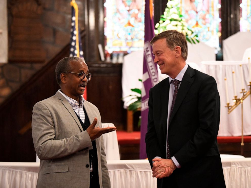 PHOTO: Former Colorado Gov. John Hickenlooper discusses gun control and death penalty issues with Anthony Thompson on Saturday, April 6, 2019, in Charleston, S.C. Thompsons wife was slain in a massacre at a historic black church in South Carolina.
