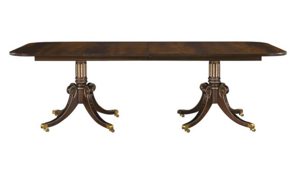 PHOTO: A "Newport Dining Table Top" from Hickory Chair Furniture Co. with optional dark walnut finish with antique rub light gold striping is pictured in a photo from hickorychair.com.