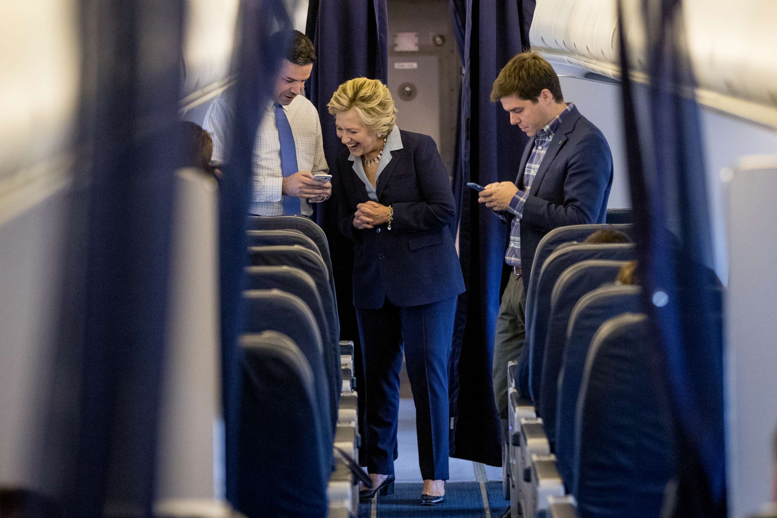 PHOTO: Democratic presidential candidate Hillary Clinton speaks with National Press Secretary Brian Fallon, left, aboard her campaign plane in White Plains, N.Y., Oct. 3, 2016, before traveling to Toledo, Ohio. 