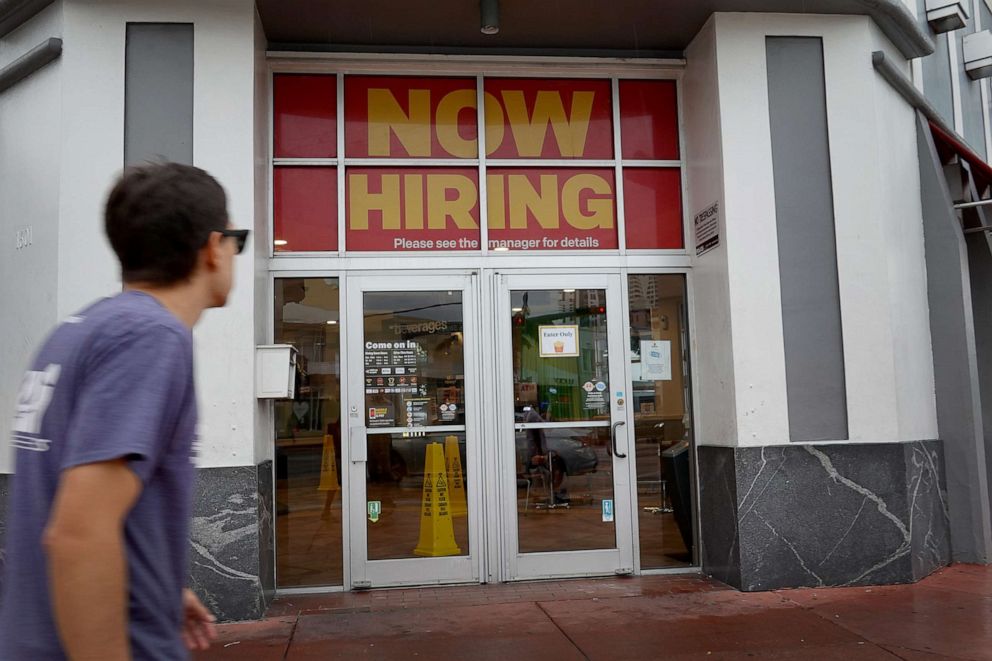 PHOTO: A "Now Hiring" sign hangs above the entrance to a McDonald's restaurant on Nov. 5, 2021, in Miami Beach, Fla.