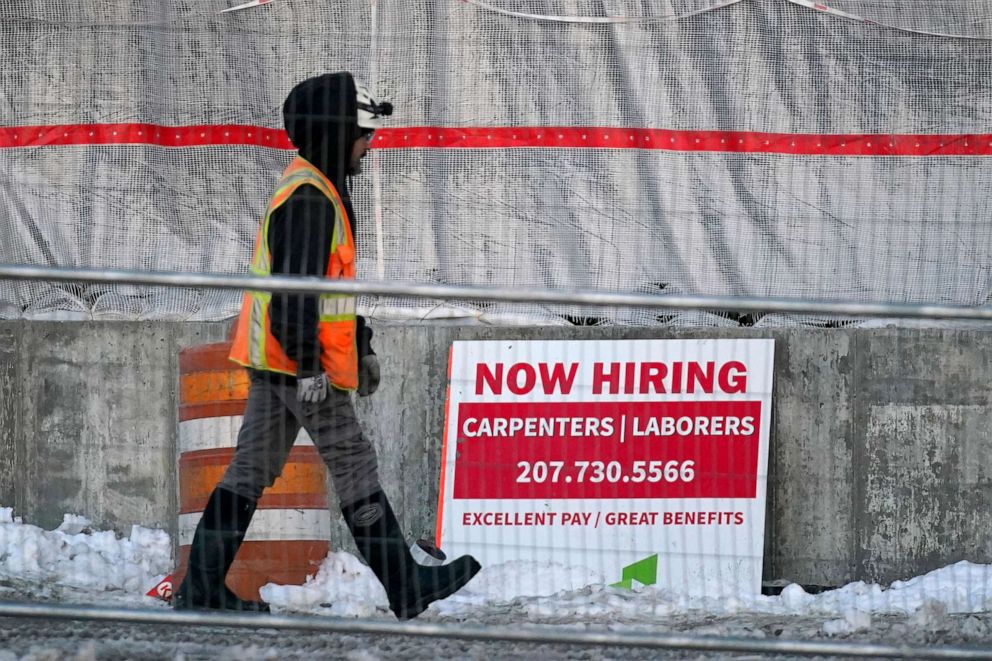 PHOTO: A worker passes a hiring sign at a construction site, Jan. 25, 2023, in Portland, Maine.