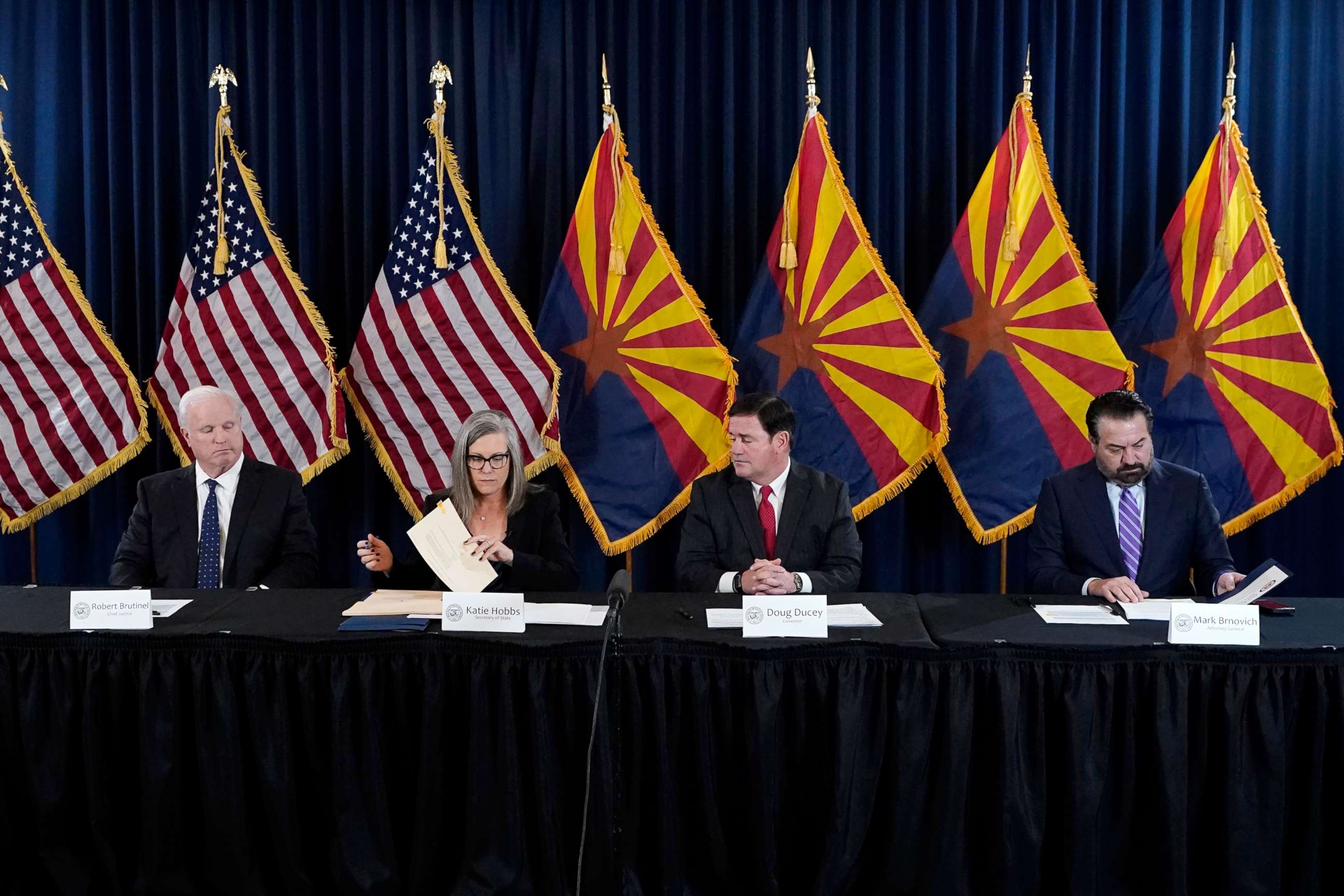 PHOTO: Arizona Democrat governor-elect and current Arizona Secretary of State Katie Hobbs, second from left, signs the official certification for the Arizona general election canvass in a ceremony at the Arizona Capitol in Phoenix, Dec. 5, 2022.