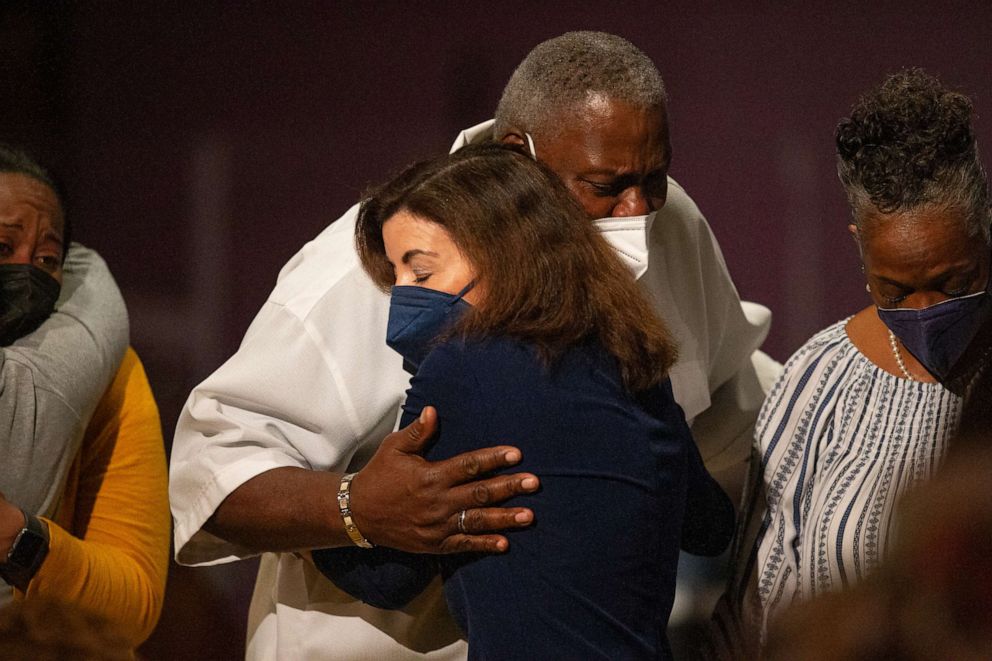 PHOTO: New York Gov. Kathy Hochul hugs Charles Everhart Sr. as service ends at True Bethel Baptist Church on Sunday, May 15, 2022, in Buffalo, N.Y.