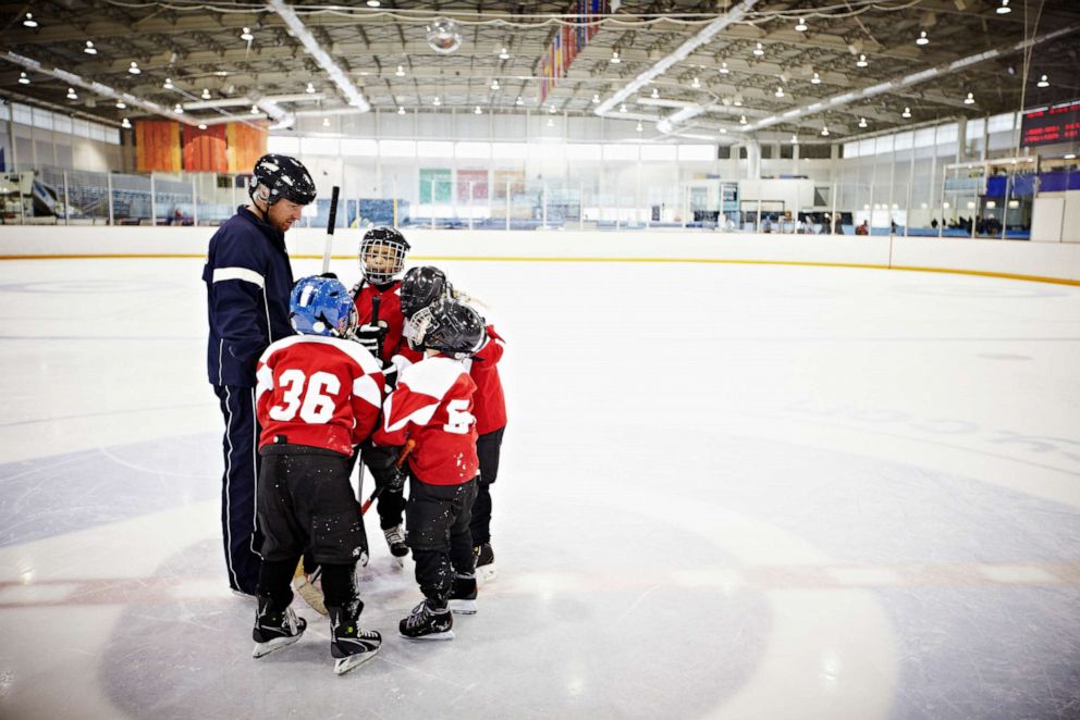 PHOTO: In this undated file photo, a coach encourages his team of young hockey players.