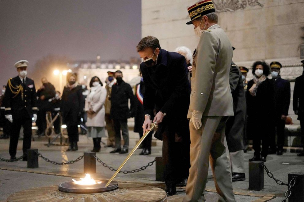 PHOTO: French President Emmanuel Macron revives the flame at the Tomb of the Unknown Soldier under the Arc de Triomphe to mark the International Holocaust Remembrance Day in Paris, Jan. 27, 2022.