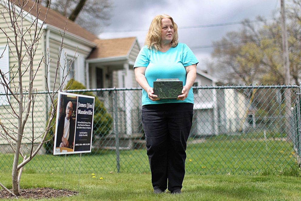 PHOTO: Laurie Beaudette holds the remains of her father, Jim Mandeville, who died April 14 at 83 of coronavirus after 16 years at Holyoke Soldiers' Home, on May 1, 2020 in Springfield, Mass.
