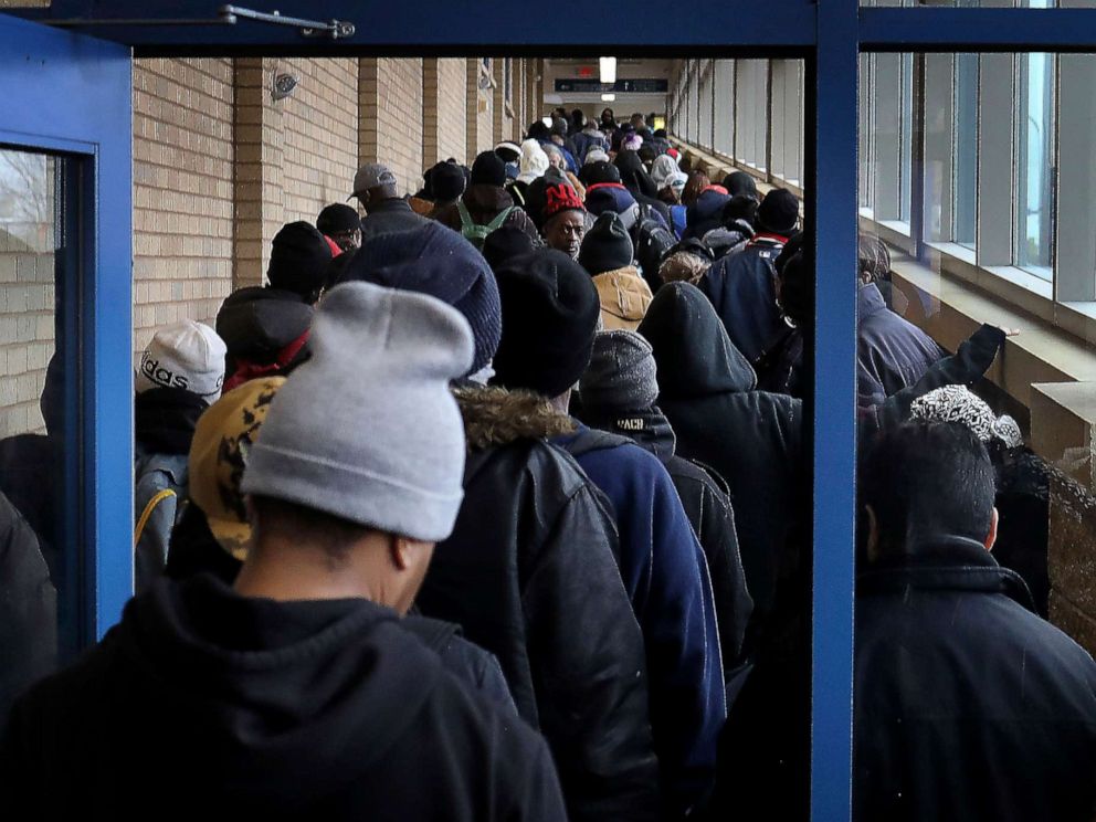 PHOTO: For some social distancing works, for the poor and homeless, getting food to eat doesn't always allow that as evidenced by the line for lunch at Sharing & Caring Hands, March 24, 2020, in Minneapolis.