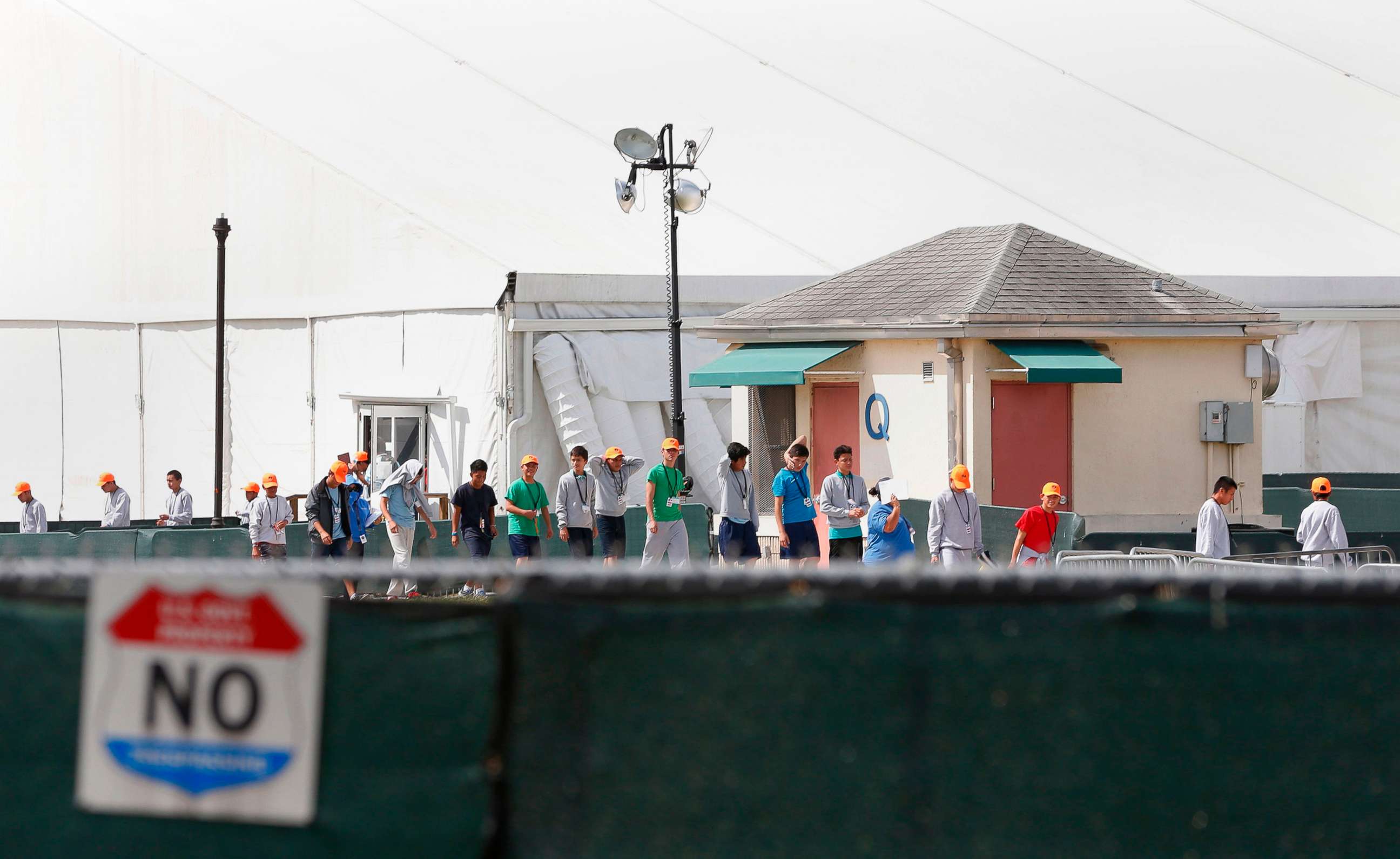 PHOTO: Migrant children who have been separated from their families walk outside shelters at a detention center in Homestead, Fla., June 27, 2019.