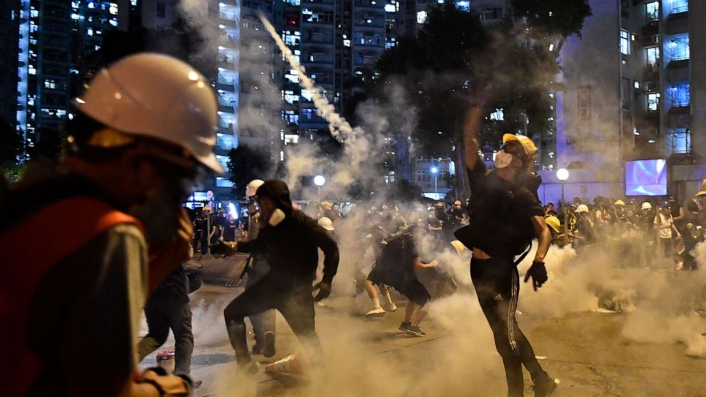 PHOTO: Protesters throw back tear gas fired by the police in Wong Tai Sin during a general strike in Hong Kong on August 5, 2019.