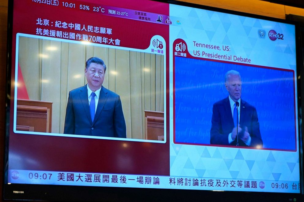 PHOTO: A TV screen broadcasts Chinese President Xi Jinpin speaking at an event and U.S. Democratic presidential candidate former Vice President Joe Biden speaking at the U.S. presidential debate, at a restaurant in Hong Kong, Oct. 23, 2020.