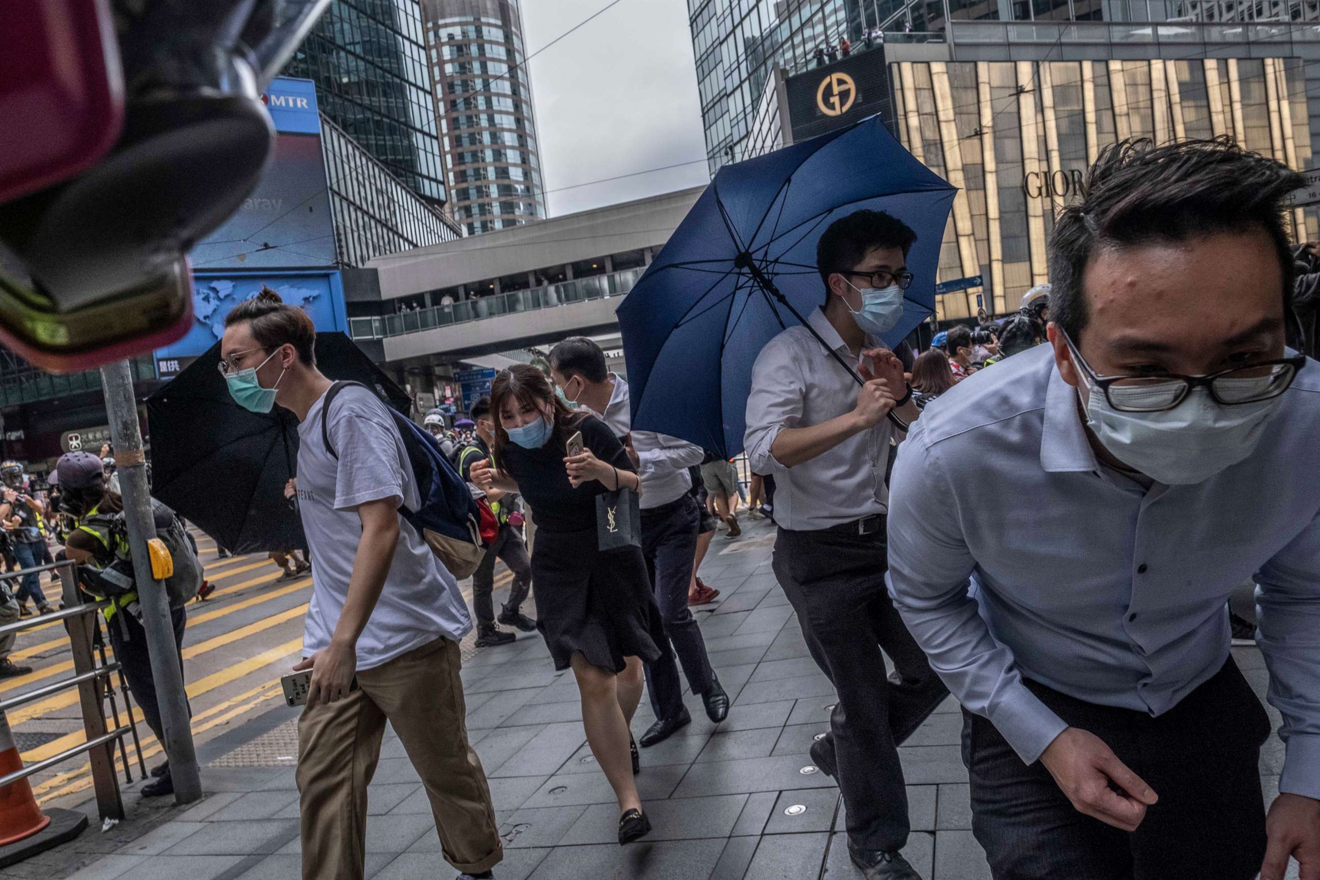 PHOTO: Protesters and bystanders crouched low after the police fired pepper balls in Central, a business district in Hong Kong, on Wednesday, May 27, 2020.