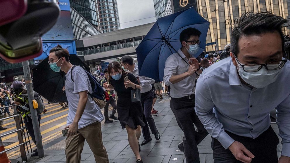 PHOTO: Protesters and bystanders crouched low after the police fired pepper balls in Central, a business district in Hong Kong, on Wednesday, May 27, 2020.